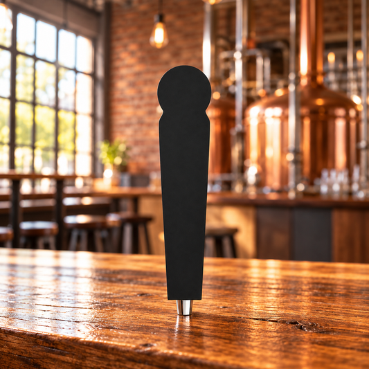 Mural 12 black tap handle with integrated circular top and chrome ferrule on a brewery counter.