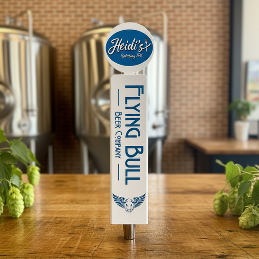 Flying Bull beer tap handle on a wooden table with brewing equipment in the background